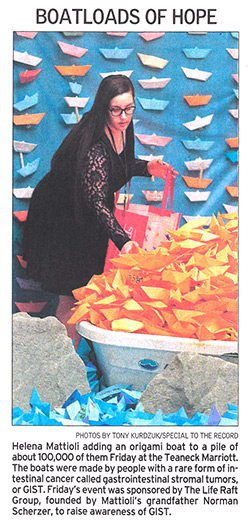 The Bergen Record photo of Helena Mattioli adding an origami boat display at Life Fest 2014